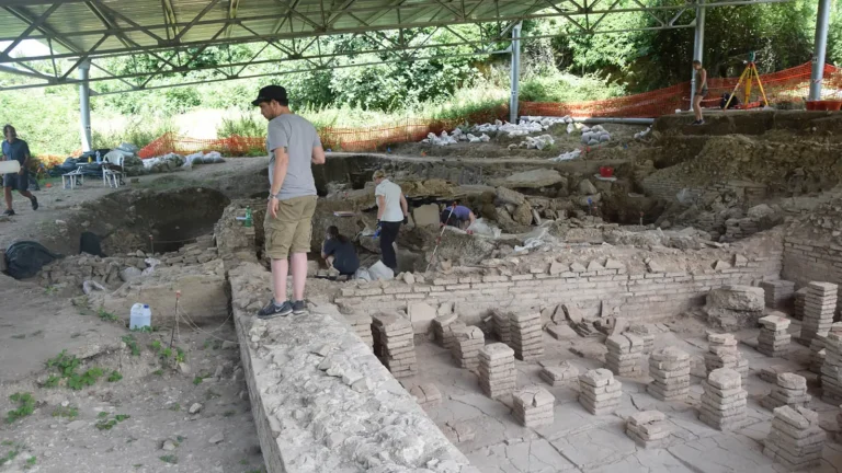 Archaeologists excavating the Roman bath complex at Carsulae in Italy