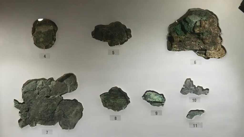 Corroded bronze fragments of the Antikythera mechanism in the National Archaeological Museum in Athens