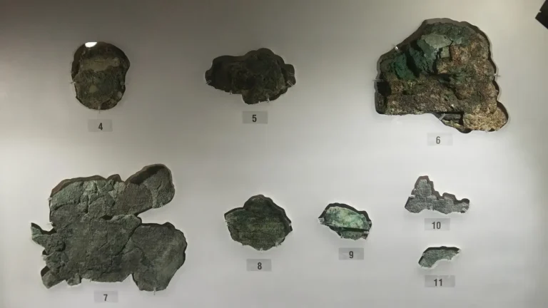 Corroded bronze fragments of the Antikythera mechanism in the National Archaeological Museum in Athens