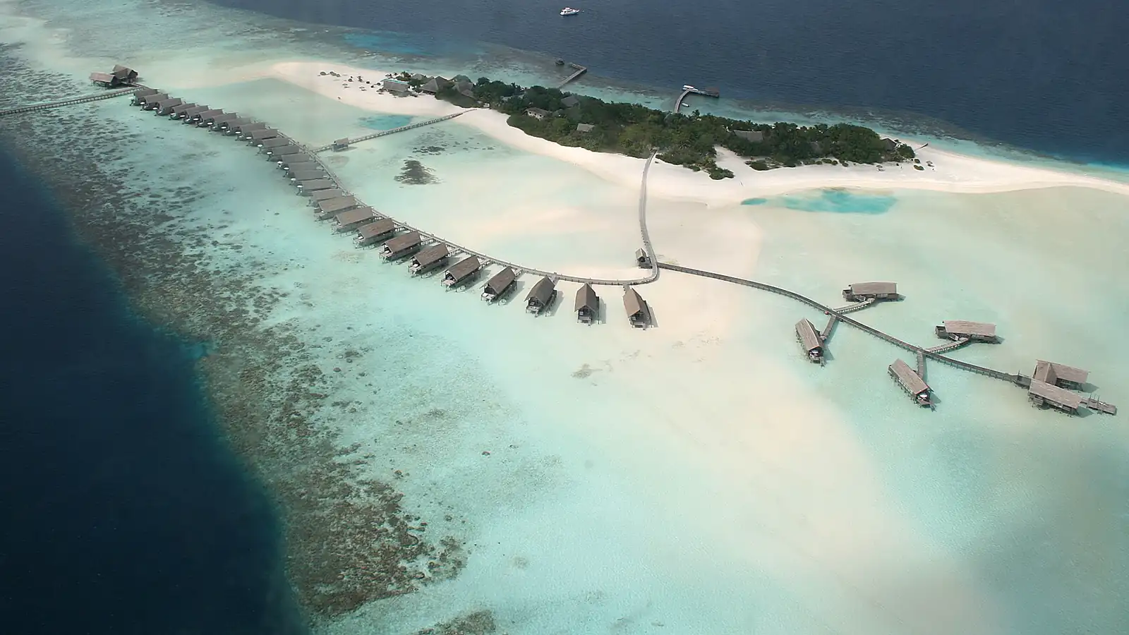 Aerial view of a coral reef, turquoise lagoon and reef island