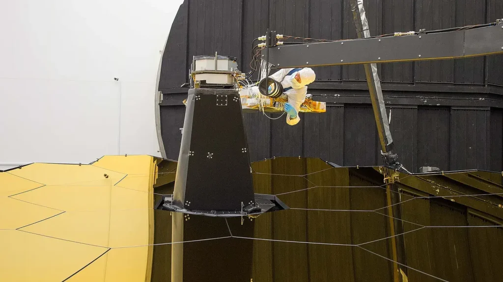 Engineer connecting fiber-optic cables to precision aerospace equipment