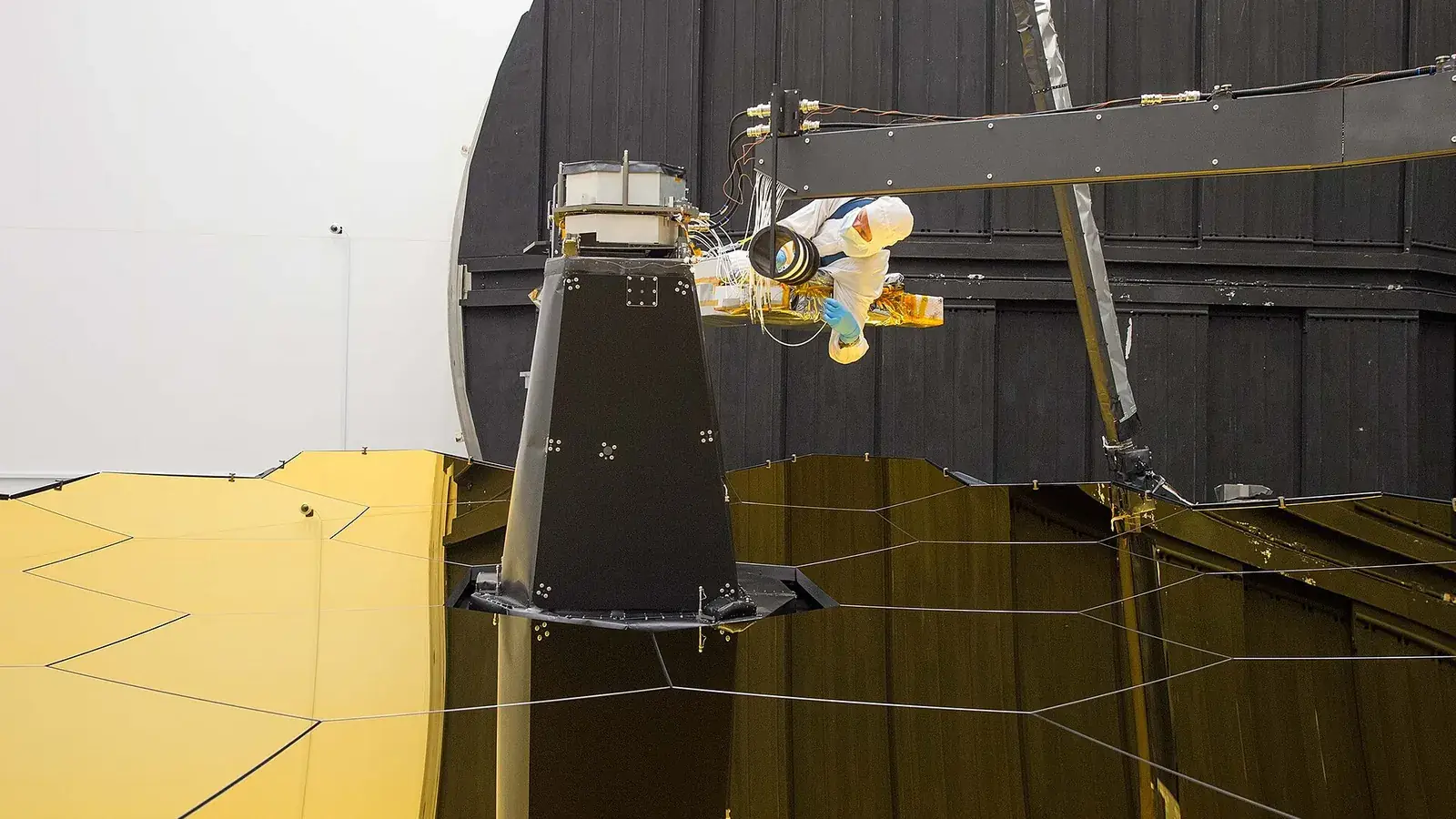 Engineer connecting fiber-optic cables to precision aerospace equipment
