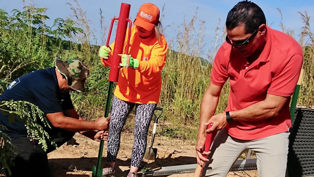 USGS scientist installing a temporary seismometer in the ground
