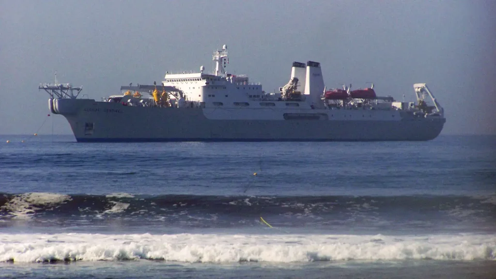 Submarine communications cable being handled aboard a cable-laying ship