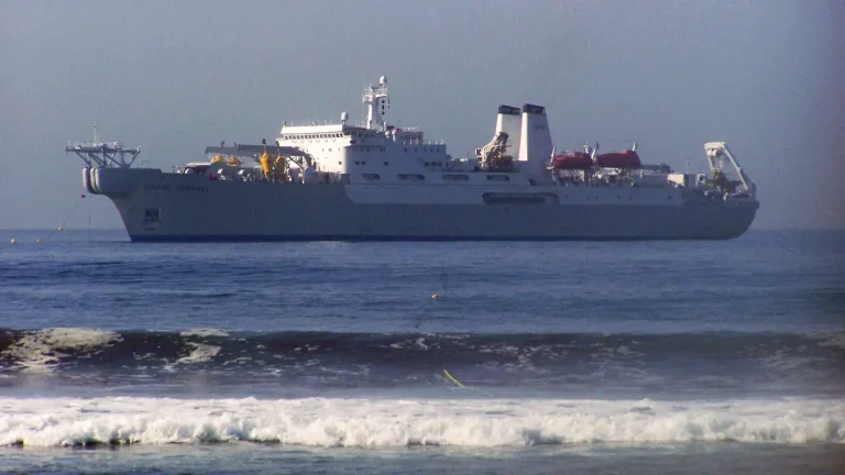 Submarine communications cable being handled aboard a cable-laying ship