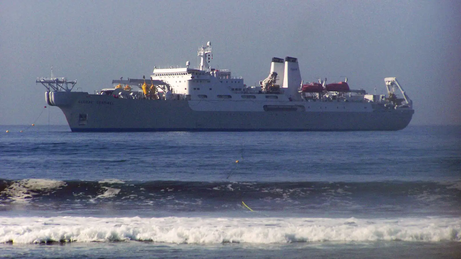 Submarine communications cable being handled aboard a cable-laying ship