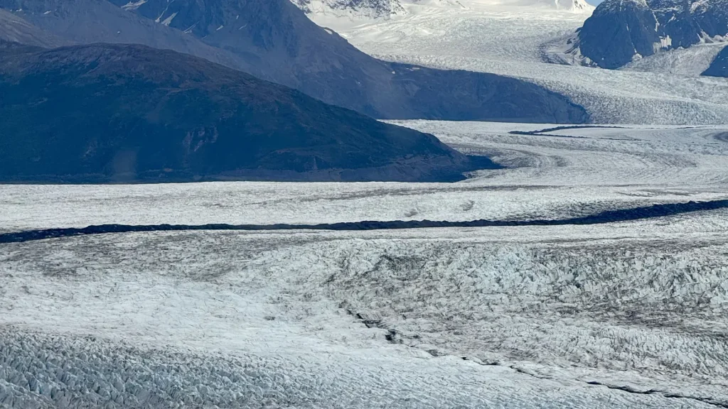 Knik Glacier winding through rugged mountains in Alaska