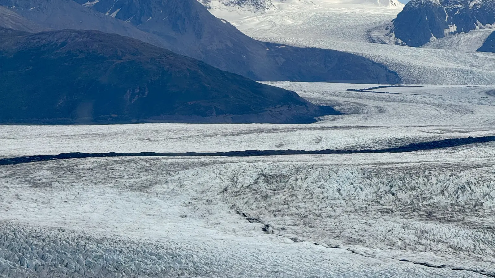 Knik Glacier winding through rugged mountains in Alaska