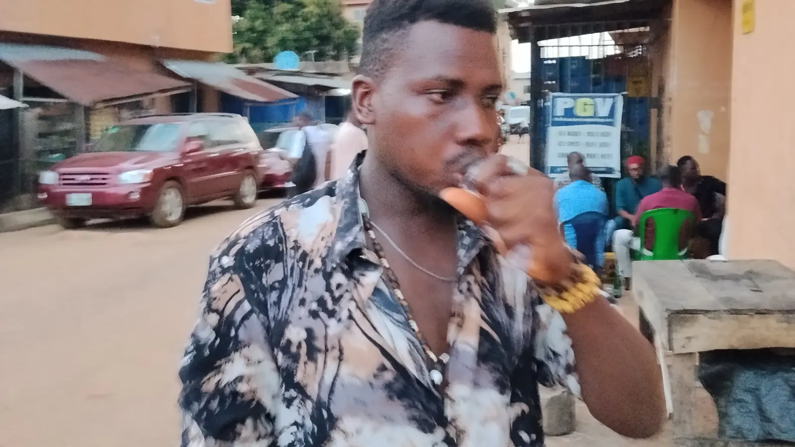 Man drinking water from a clear bottle outdoors