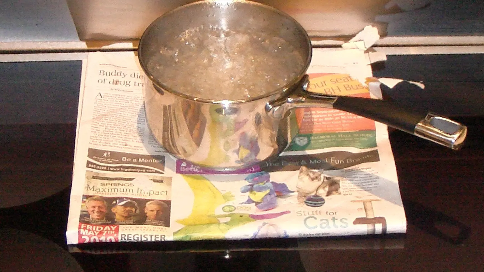 Pot of water boiling on a black induction cooktop