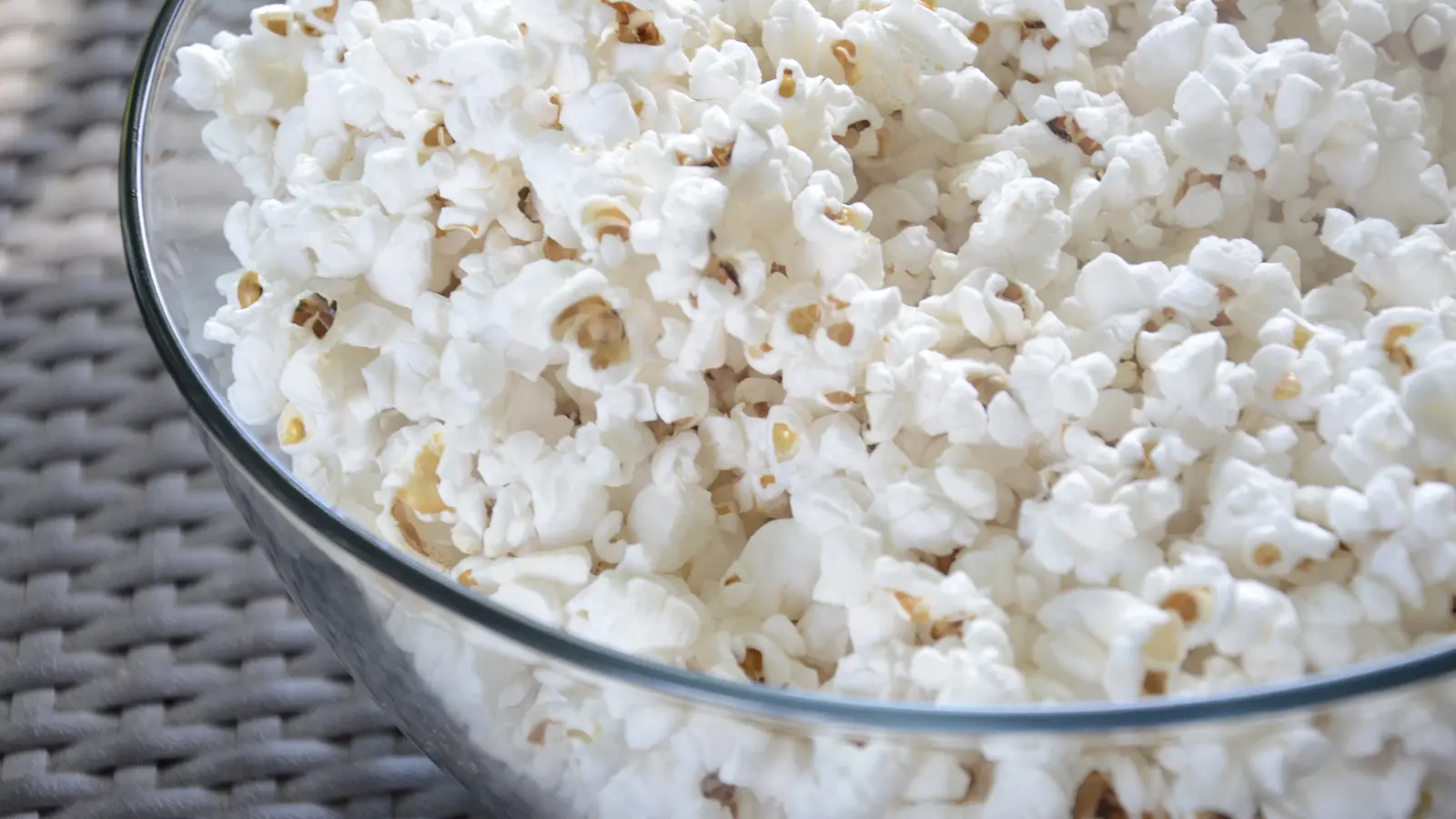 Close-up bowl filled with freshly popped white popcorn