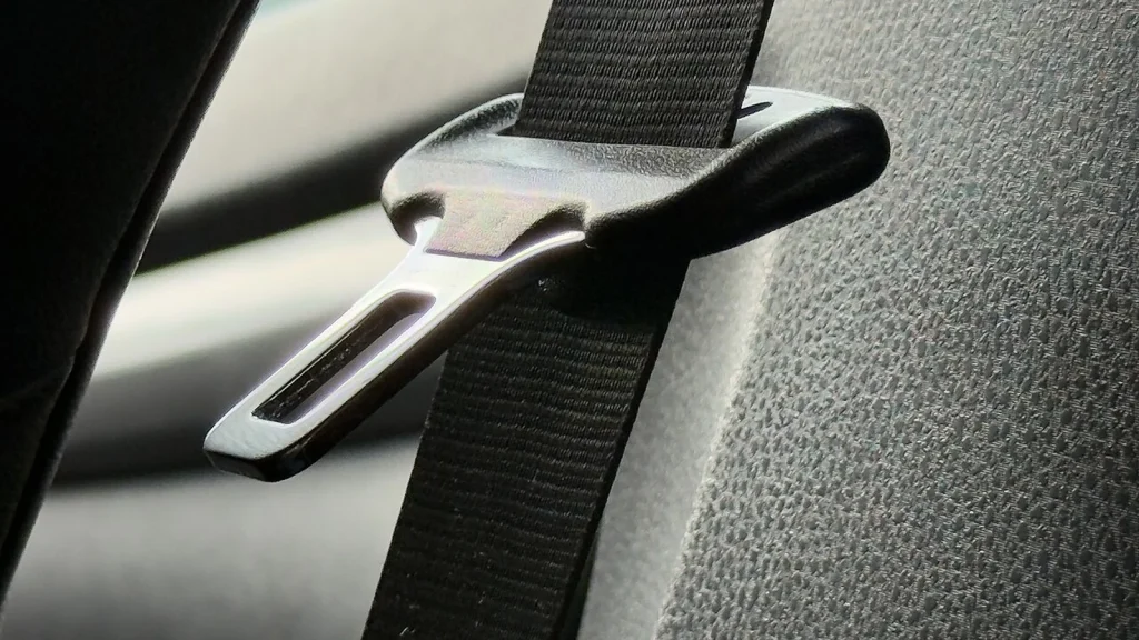 Three-point seat belt fastened across the seat of a modern passenger car