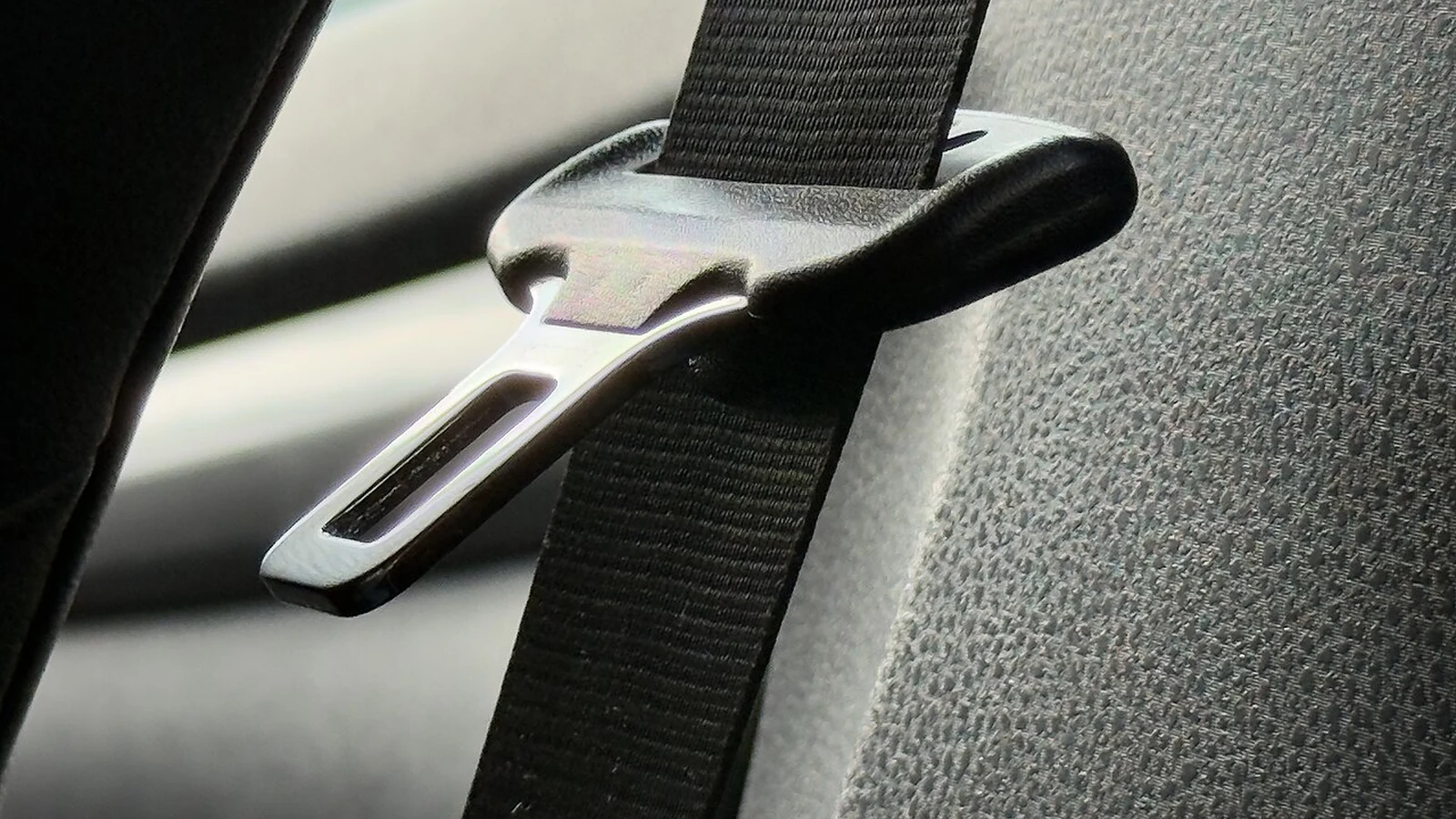 Three-point seat belt fastened across the seat of a modern passenger car