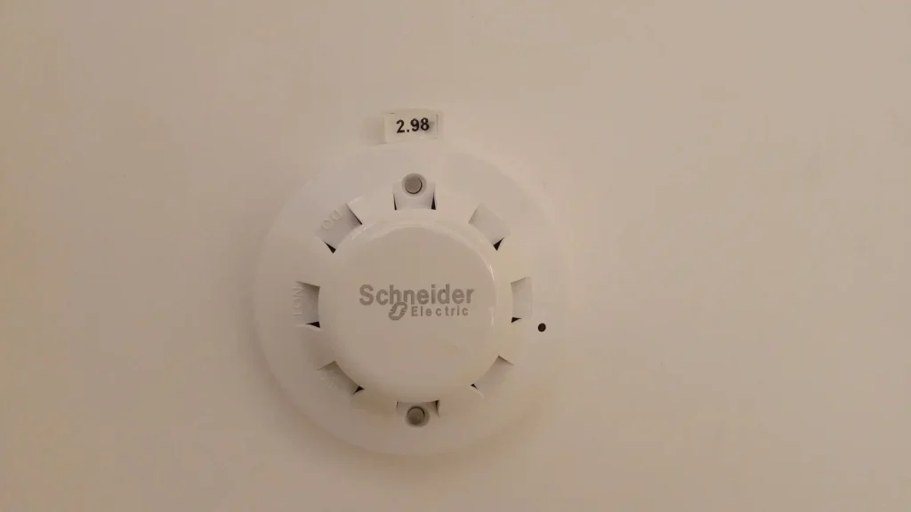 Round white smoke detector designed for ceiling installation