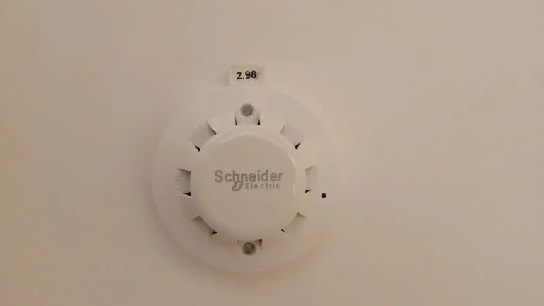 Round white smoke detector designed for ceiling installation