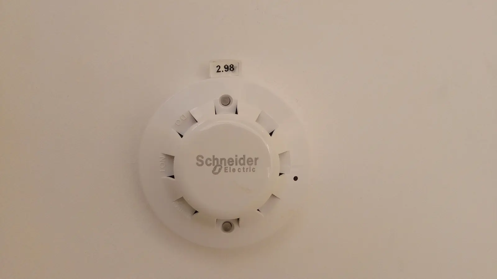 Round white smoke detector designed for ceiling installation