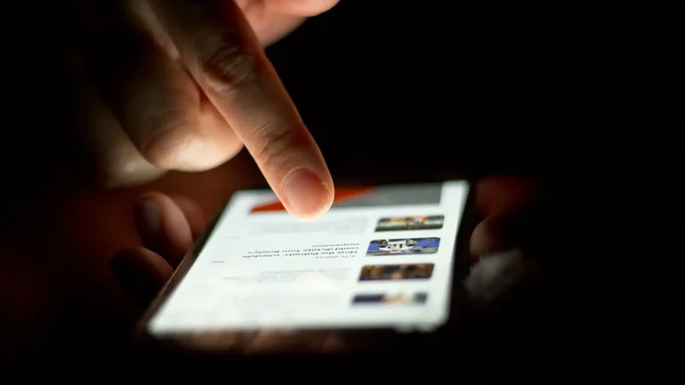 Person scrolling on a smartphone touchscreen with one finger
